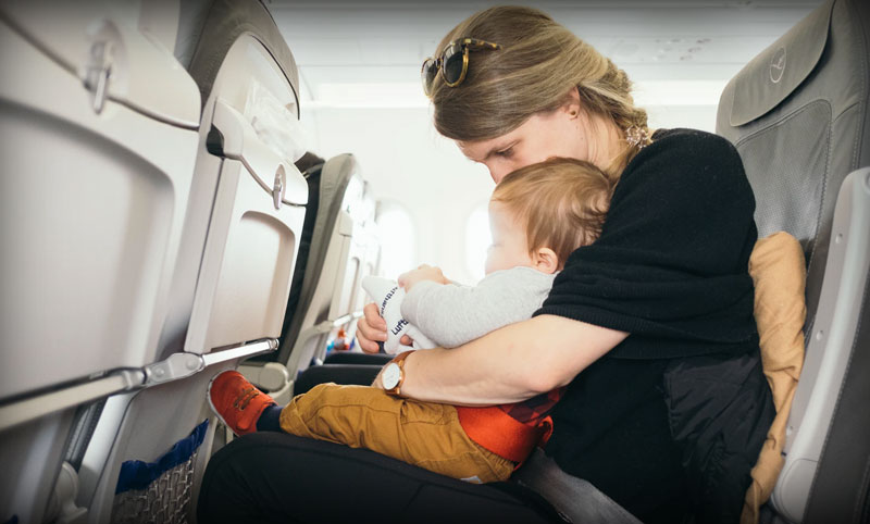 Mother flying with baby